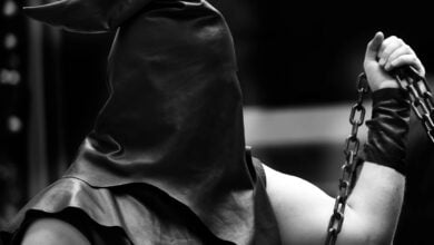 executioner with black hood on his head and the chain