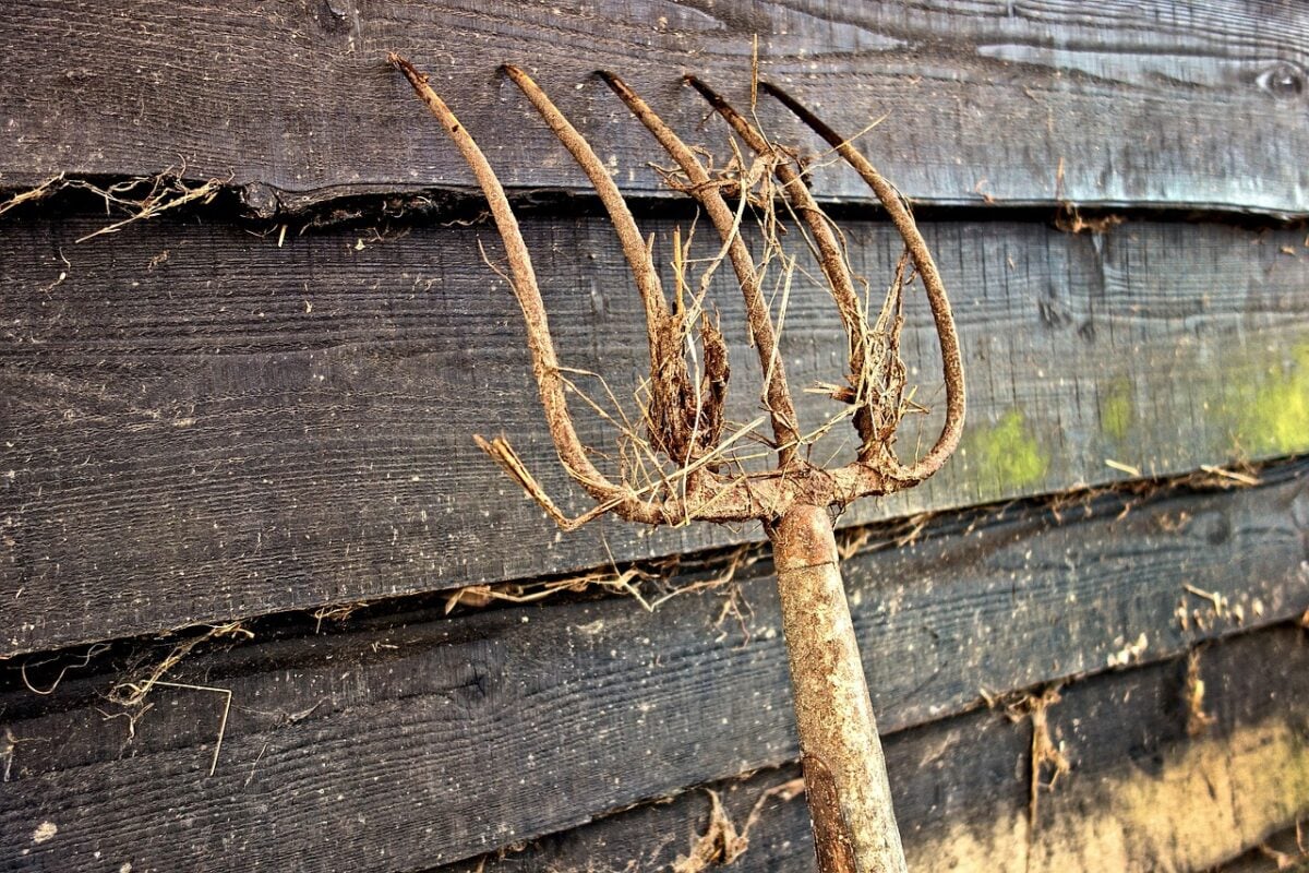 Pitchfork against a barn wall