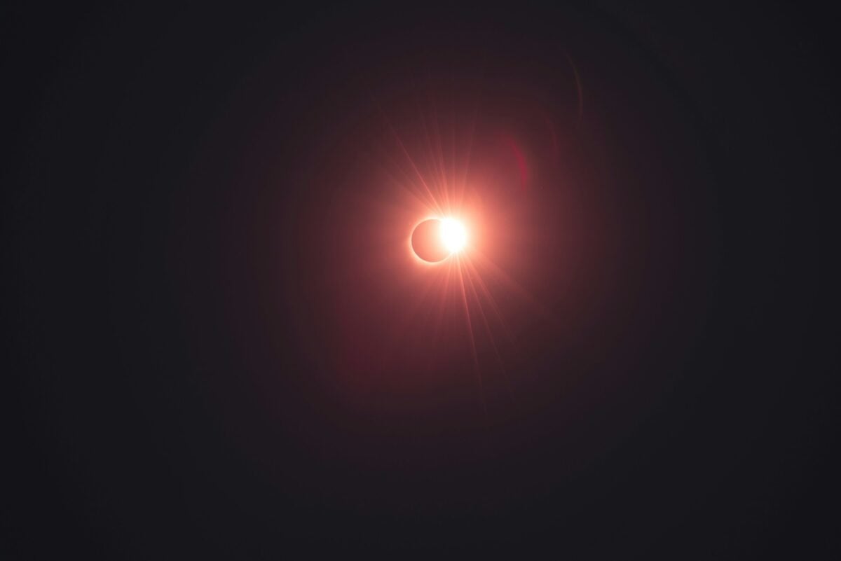 This is the Diamond Ring just after Totality, with a slight red hue applied.